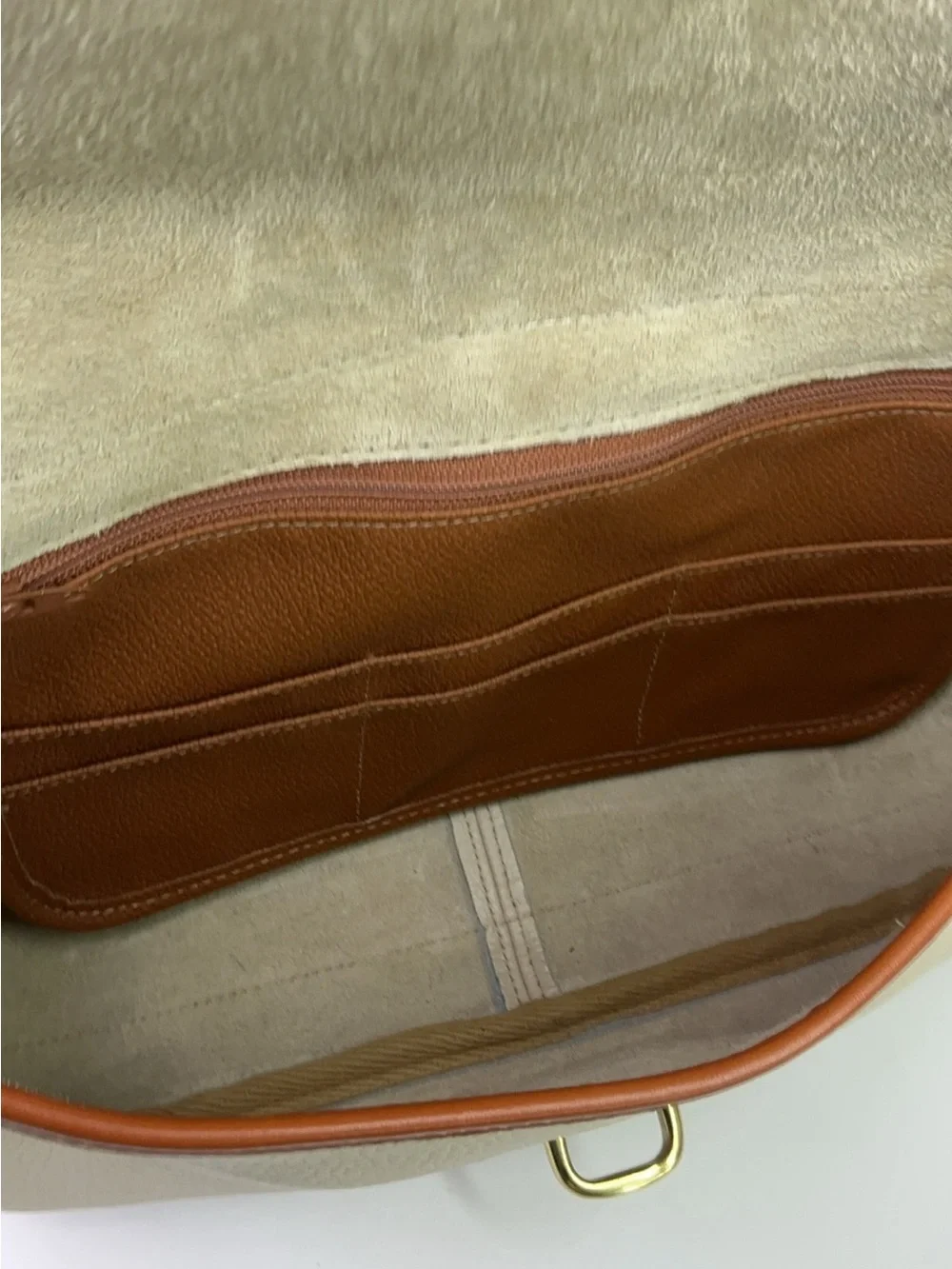 Dooney & Bourke cream and tan pebbled leather saddle bag